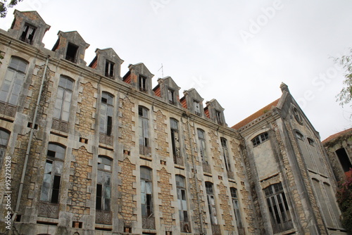 Old buildings in Parque Dom Carlos I, located in Caldas da Rainha, Portugal.  These historic stone structures are set amidst lush greenery, creating a peaceful and picturesque scene. photo