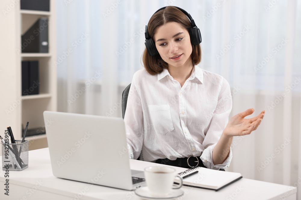 Teenager in headset having video chat via laptop at home. Remote work Teenager in headset having video chat via laptop at home. Remote work