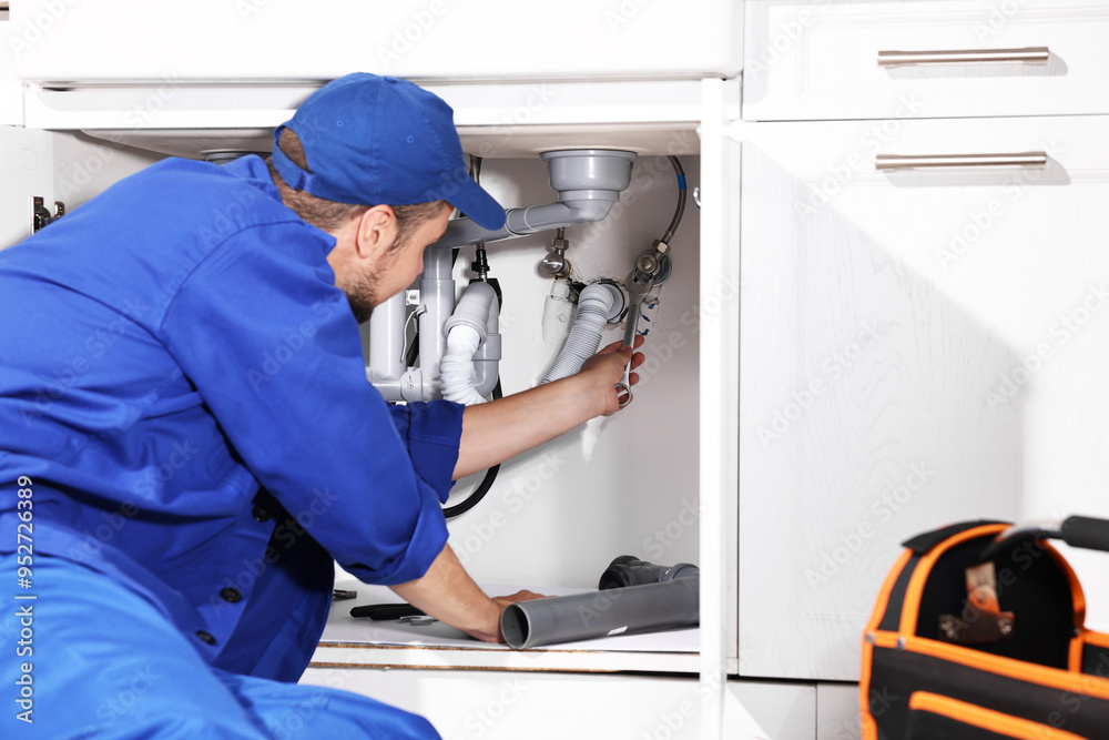 Professional plumber fixing piping system at home Professional plumber fixing piping system at home