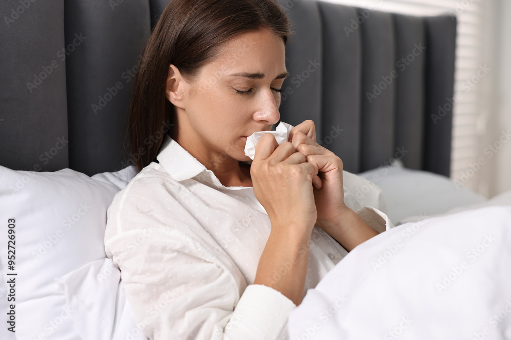 Sick woman with tissue in bed. Cold symptoms Sick woman with tissue in bed. Cold symptoms