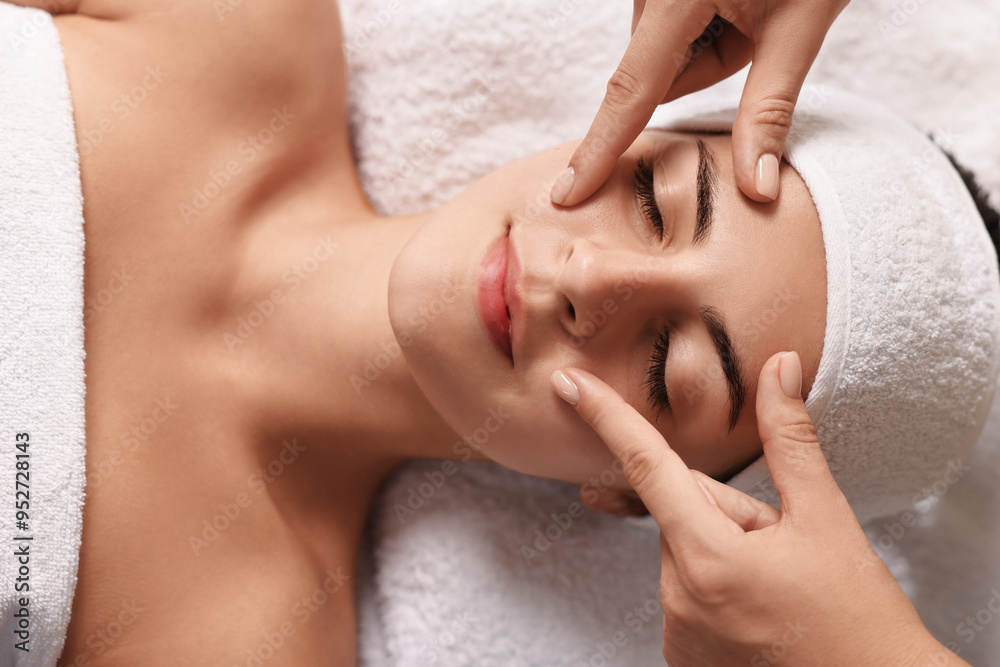 Attractive woman enjoying face massage, top view. Beauty procedure Attractive woman enjoying face massage, top view. Beauty procedure