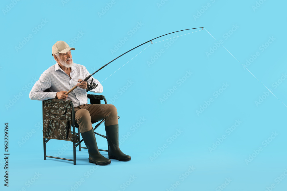 Fisherman with rod on fishing chair against light blue background Fisherman with rod on fishing chair against light blue background