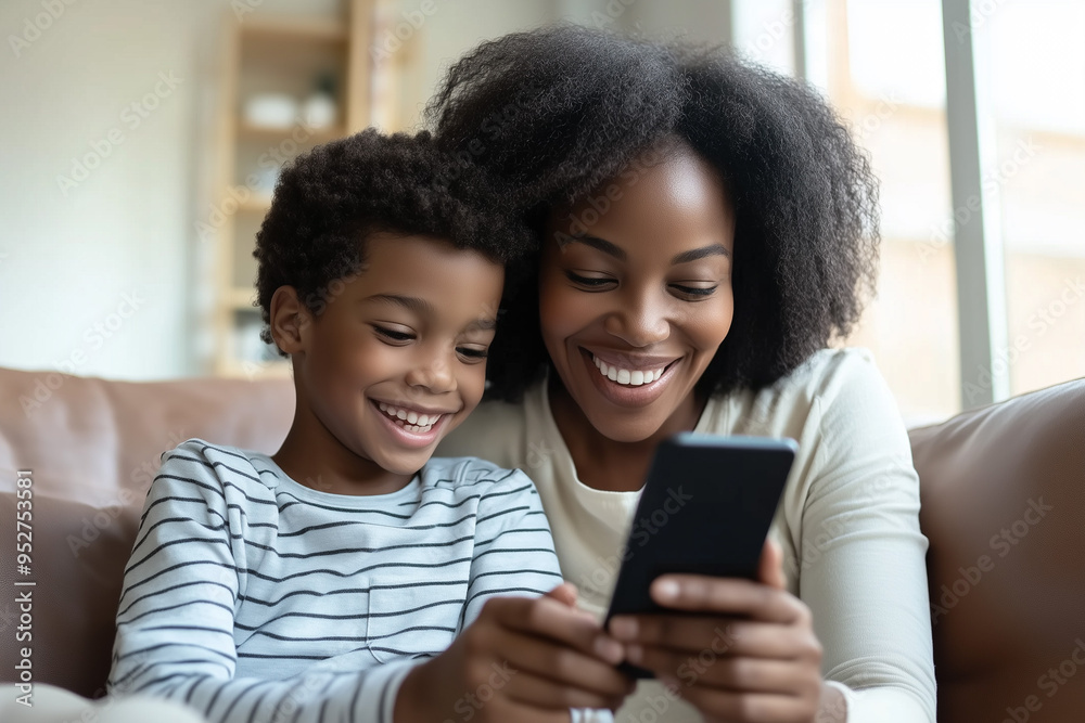 Close-Up of Mother and Son Using Smartphone. African mother and son smiling looking at smartphone, ideal for family and technology themes. Close-Up of Mother and Son Using Smartphone. African mother and son smiling looking at smartphone, ideal for family and technology themes.