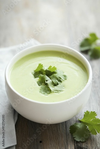 A rich coconut and green curry soup topped with vibrant cilantro adds a refreshing touch to every bowl.