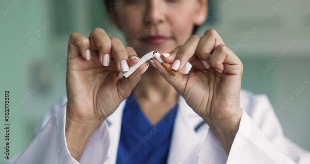 Close up woman doctor breaking cigarette as symbol of smoking cessation, act of quitting smoking, promote healthy lifestyle. Social campaign to help smokers overcome nicotine addiction, improve health