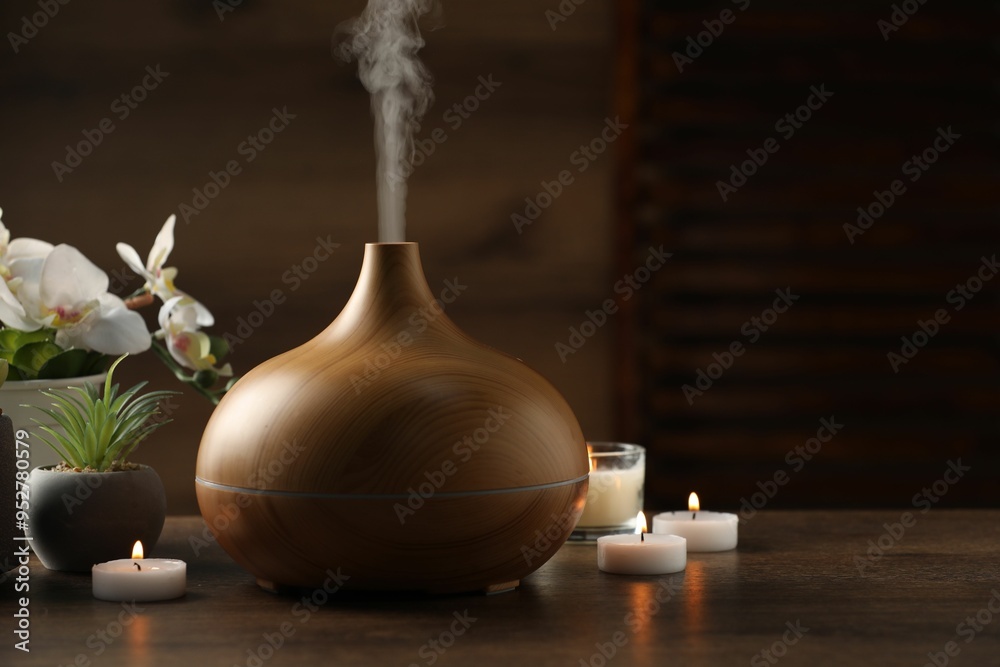 Aroma oil diffuser, burning candles and houseplants on wooden table Aroma oil diffuser, burning candles and houseplants on wooden table