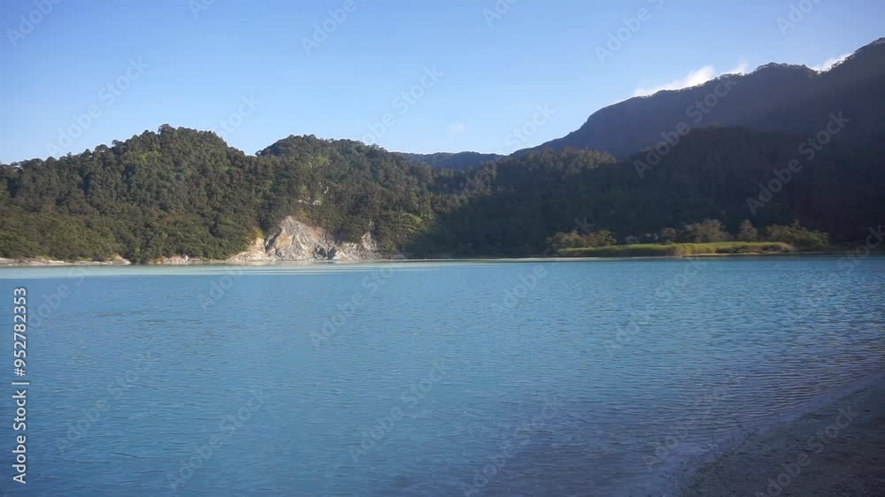 talaga bodas crater, a tourist attraction in garut indonesia, with green trees under a bright blue sky in the afternoon