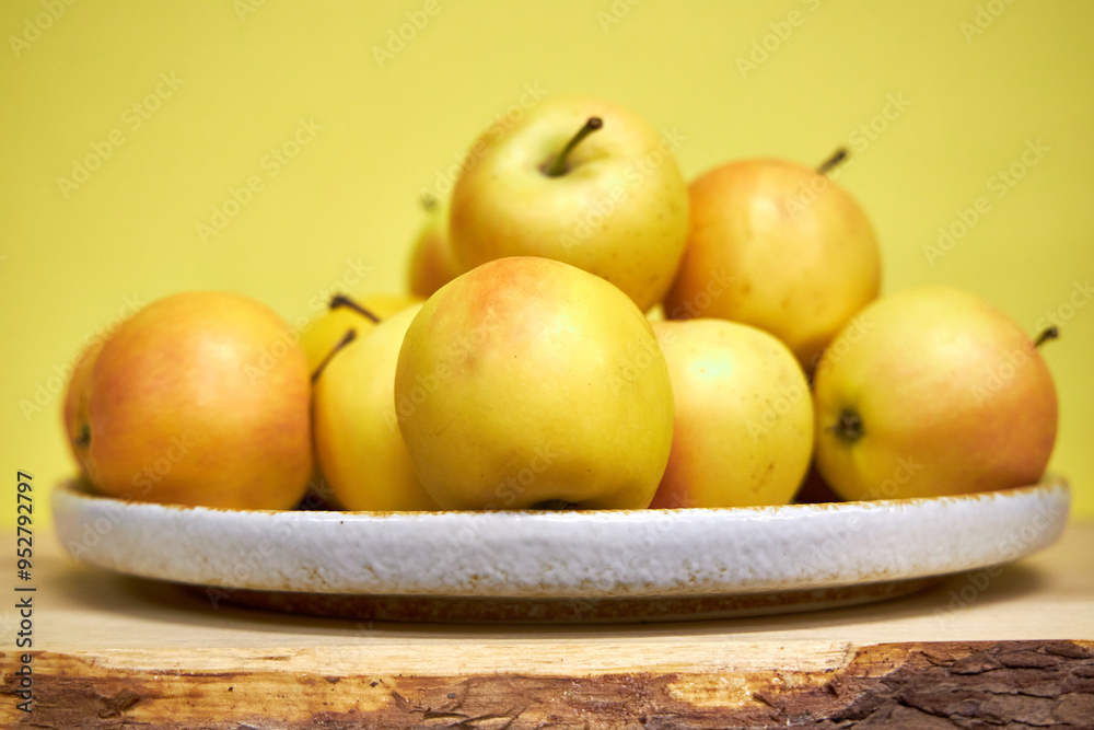 Modern minimalist still life with yellow apples on yellow background Modern minimalist still life with yellow apples on yellow background