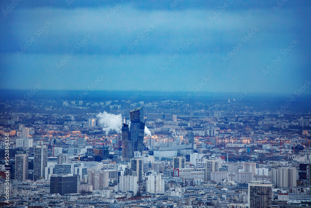Fototapeta premium Last sun beams falling on Paris roofs before dusk, aerial view