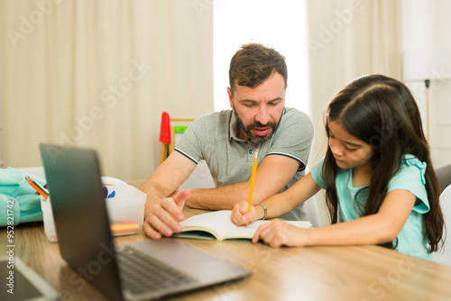 Tableau sur toile Father homeschooling her daughter and helping her solve a few math problems