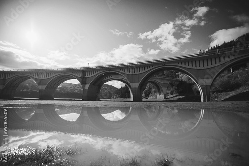 Piatra Teiului lime stone and Bicaz lake viaduct with reflexion, Romania. Viaduct in countryside. Viaduct at Lacul Izvorul Muntelui, Moldova, Romania. black and white picture photo