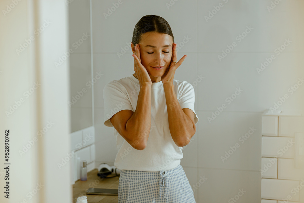 A calm woman enjoys her selfcare routine in her bathroom, a safe haven for relaxation A calm woman enjoys her selfcare routine in her bathroom, a safe haven for relaxation