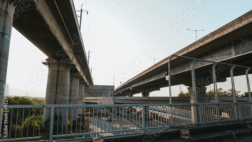 Bekasi, Indonesia. August 25, 2024: Urban overpass with metal fences, capturing a unique perspective of concrete architecture against a clear sky