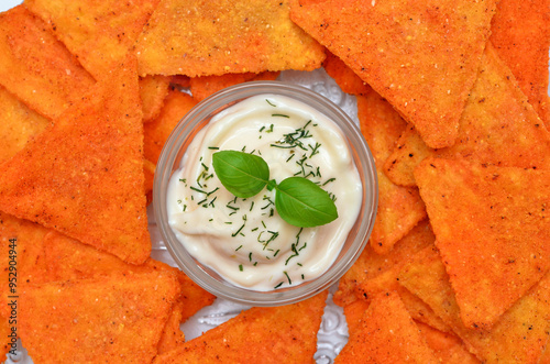 corn chips and sour cream sauce close up, mexican appetizer close up photo