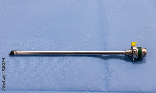 Tools for surgery on green fabric, Preparation for Gynecology surgery. Hasson Three Prong Grasper (Triple Jaw). Urology and Gynecology Surgical Instrument.