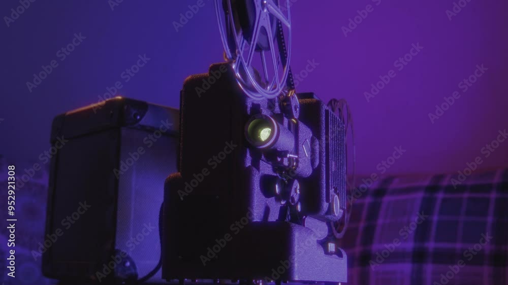Close-up of a glowing vintage 8 mm projector surrounded by dim lighting, evoking a nostalgic cinematic atmosphere. Perfect for projects with a vintage or filmic theme.
