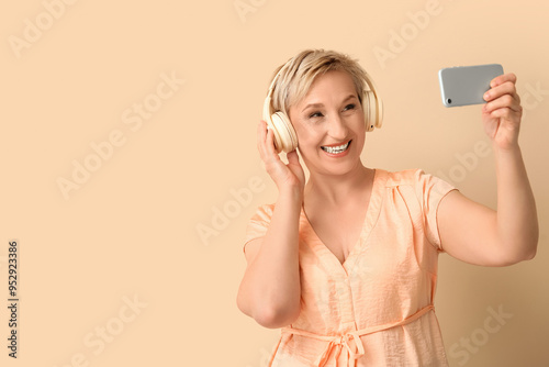 Mature woman in headphones ...