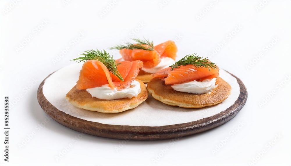delicious smoked salmon blinis with cream cheese and fresh dill on white background delicious smoked salmon blinis with cream cheese and fresh dill on white background