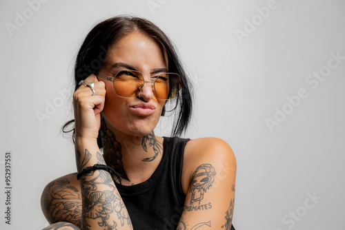 Playful portrait of a tattooed girl making a puckered lip facial expression