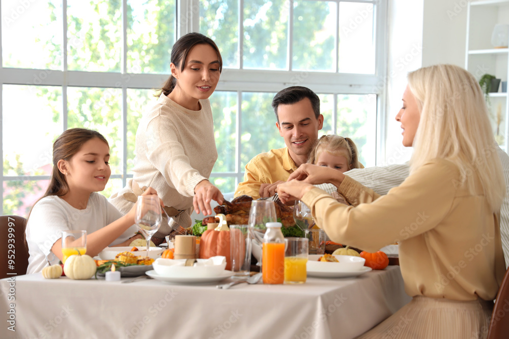 Happy family having dinner at festive table on Thanksgiving Day Happy family having dinner at festive table on Thanksgiving Day