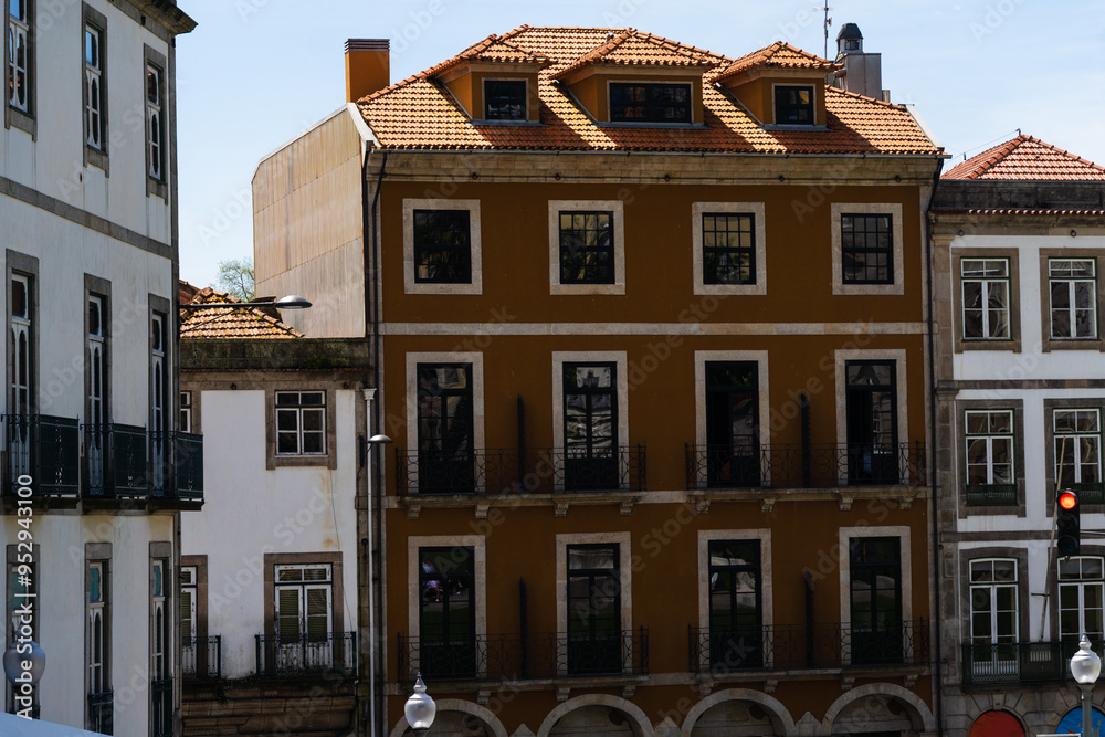 Fototapeta premium View of the city of Porto. Characteristic architecture of Porto, Vila Nova de Gaia, Portugal. Urban landscape along the river. Houses and buildings