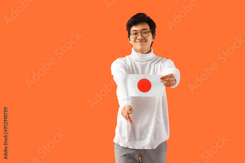 Young Asian man with flag o...