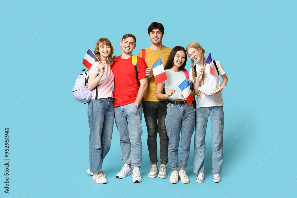 Group of students with French flags on blue background Group of students with French flags on blue background
