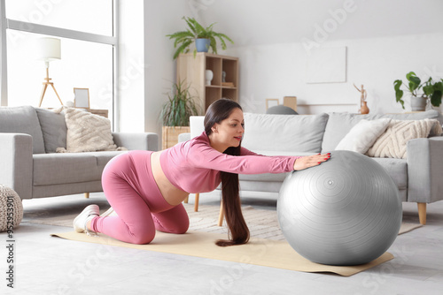 Sporty pregnant woman training with fitball at home