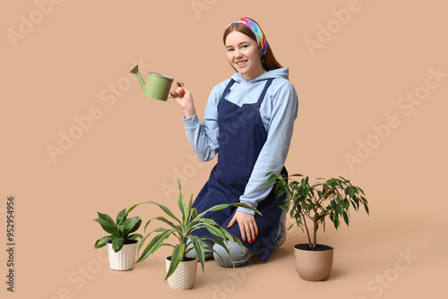Pretty young woman watering...