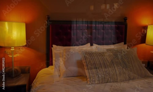 Wallpaper Mural Cozy City Lights Retreat: Inviting bedroom with warm lighting, plush bedding, and a glimpse of the city's twinkling skyline through the window. Torontodigital.ca