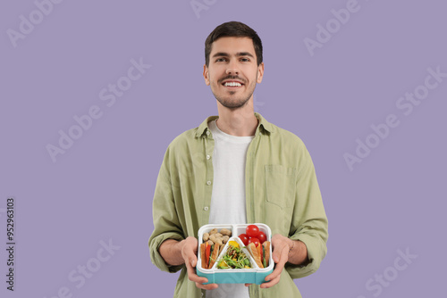 Young man with lunchbox on ...
