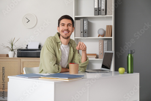 Young man having lunch at home