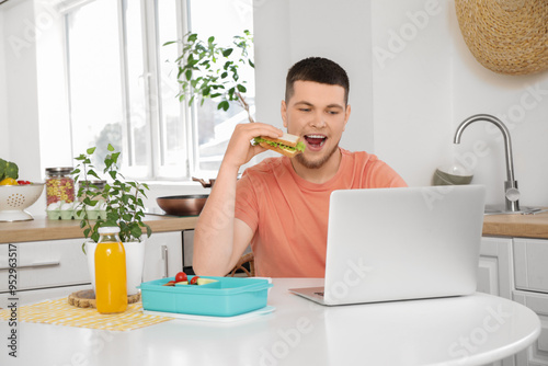 Young man with laptop and l...
