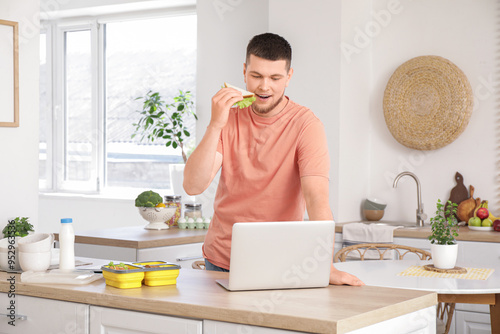 Young man with laptop and l...