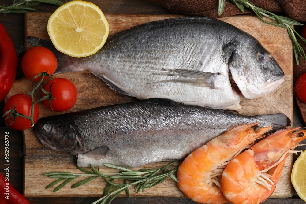 Fresh raw sea food and products on wooden table, flat lay Fresh raw sea food and products on wooden table, flat lay