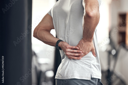 Hip pain, man and fitness injury at gym for boxing, sport and training with accident at health center. Wellness, hands and exercise of an athlete with hurt joint and scoliosis concern of spine