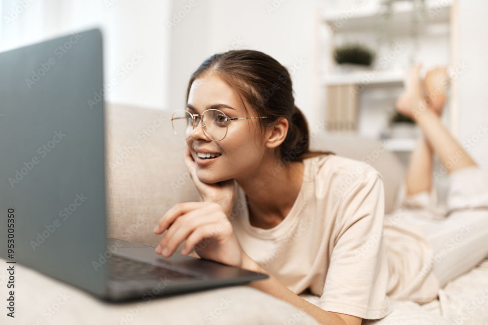 Fototapeta premium Happy Freelancer in Cozy Home Office: Smiling Woman Typing on Laptop in Modern Living Room