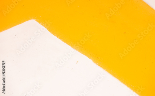 A white and yellow striped wall. The yellow stripe is the dominant color photo