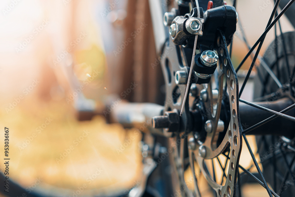 Fototapeta premium selective focus Close-up of a bicycle disc brake system, highlighting the rotor and caliper with blurred background.