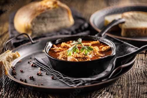 Obraz na płótnie Tasty soup or stew made of beef tripe and spices. Spicy and aromatic tripe soup seasoned with pepper and served with bread w salonie