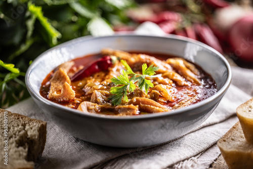 Tasty soup or stew made of beef tripe and spices. Spicy and aromatic tripe soup seasoned with pepper and served with bread photo