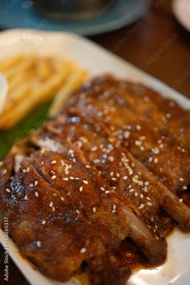 Delicious succulent pork ribs baked with honey and white sesame Delicious succulent pork ribs baked with honey and white sesame