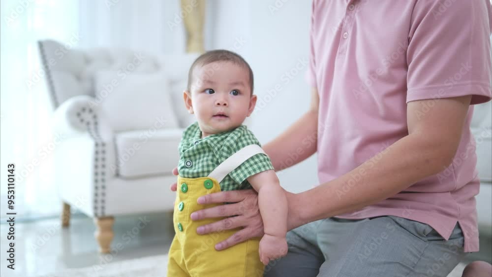 Father and their little child play happily in the living room of the house Father and their little child play happily in the living room of the house
