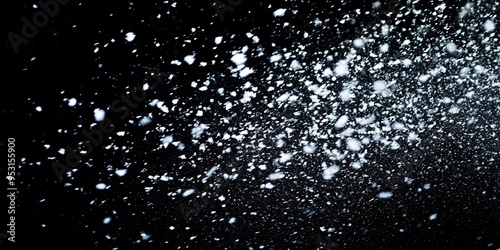 snow on black background.Snowflurry on Black: A cascade of delicate snowflakes dance against a stark black backdrop, capturing the ephemeral beauty of winter's embrace.  photo