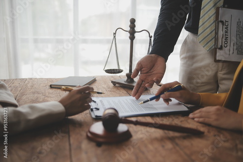 Business and lawyers discussing contract papers with brass scale on desk in office. Law, legal services, advice, justice and law concept picture with film grain effect