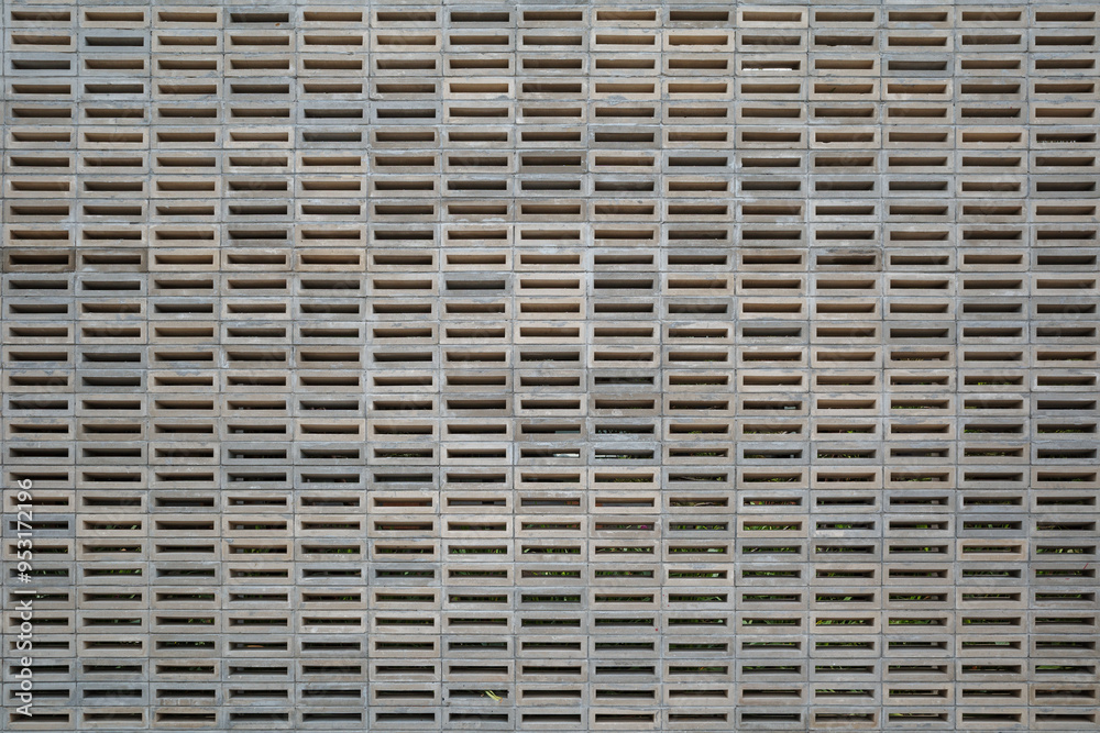 A detailed image of a concrete block wall showcasing a repetitive, geometric pattern. A detailed image of a concrete block wall showcasing a repetitive, geometric pattern.