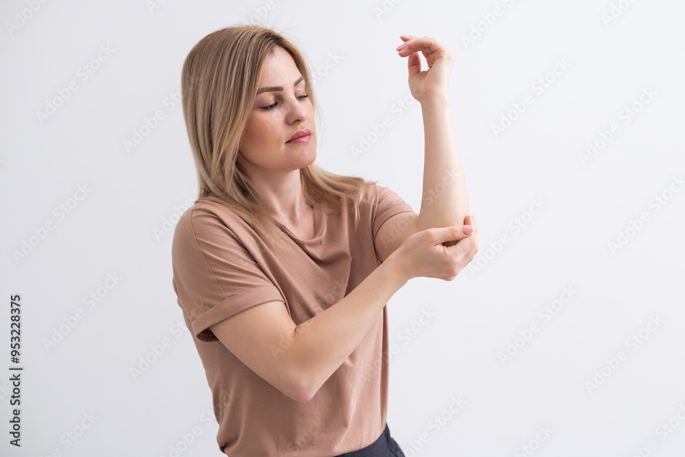 woman suffering pain in the elbow. Composite of image arm bones and elbow woman suffering pain in the elbow. Composite of image arm bones and elbow