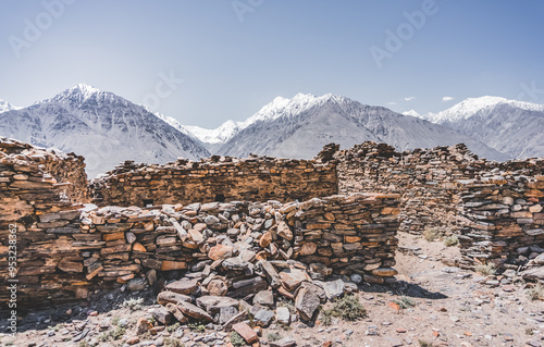 Remains of the ancient fortress of Yamchun in the Tien Shan mountains in Tajikistan in the Pamirs, ruins of a fortress fort made of stone on the background of mountains photo