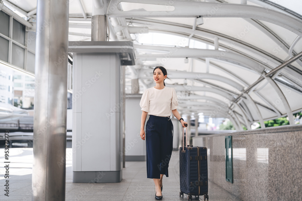 Adult business asian woman walking with luggage for work and travel at station platform on day Adult business asian woman walking with luggage for work and travel at station platform on day