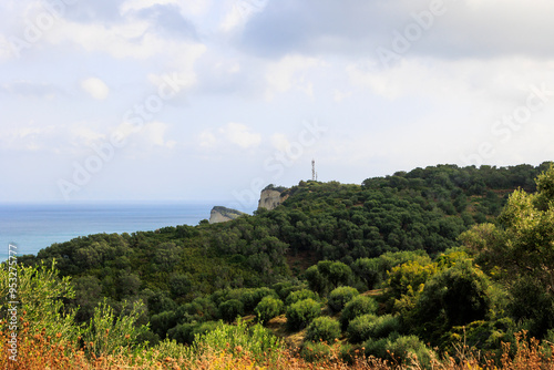  View over wooded mountains and olive plantations to Cape Drastis in the north of the island of Corfu photo